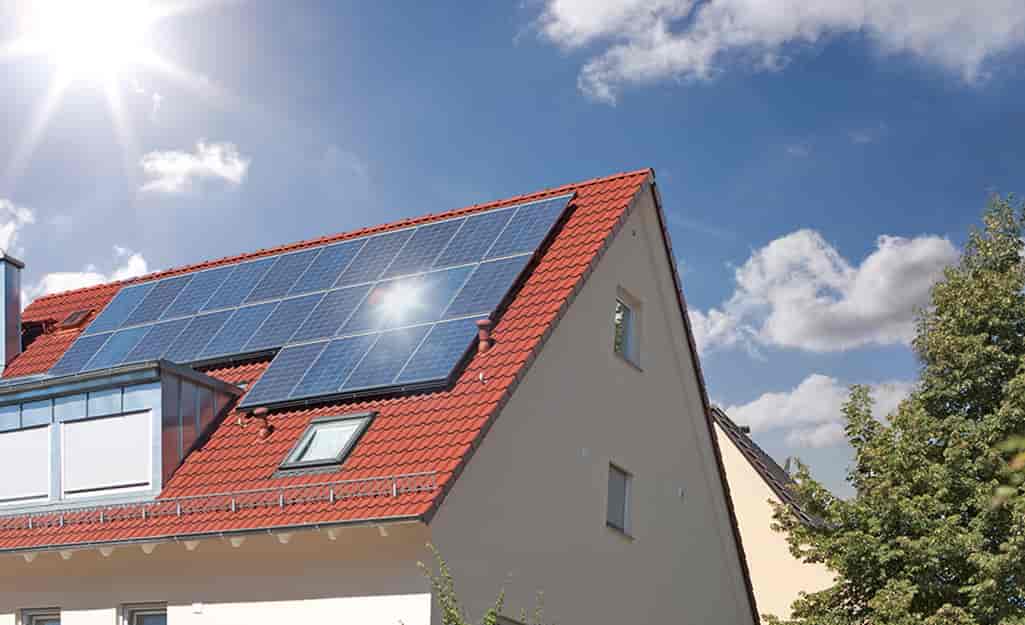 Red roof house with solar panels.